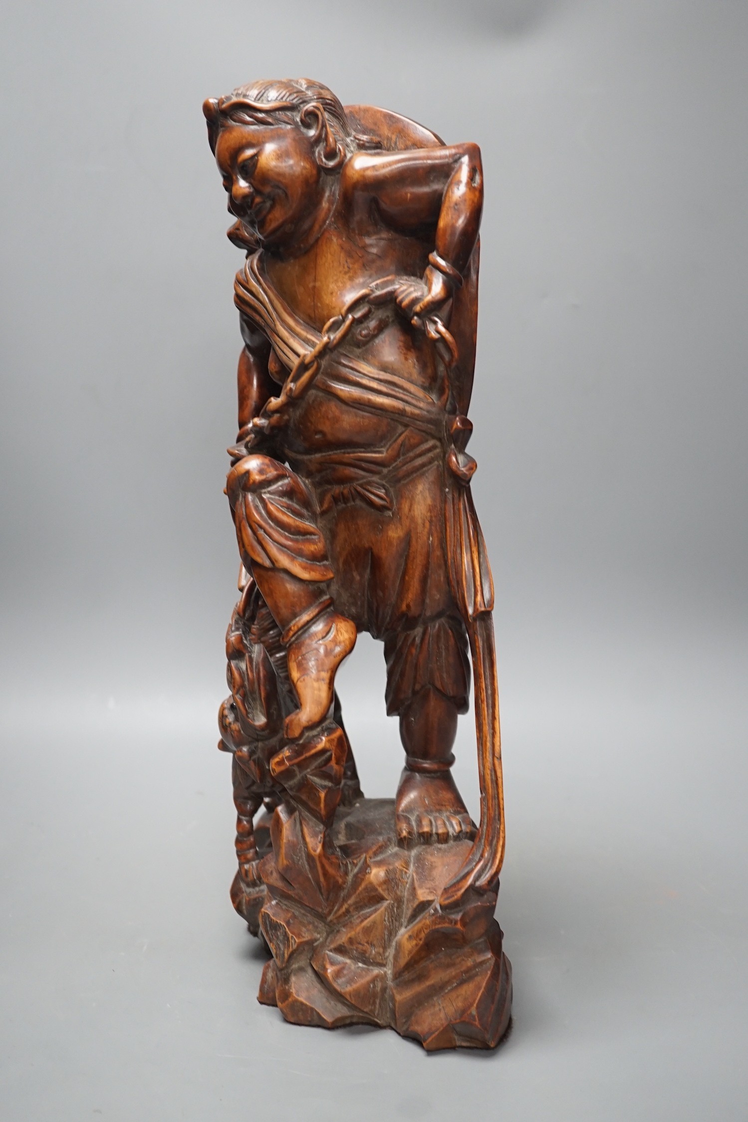 A large Chinese hardwood figure of Liu Hai, early 20th century, 47cm